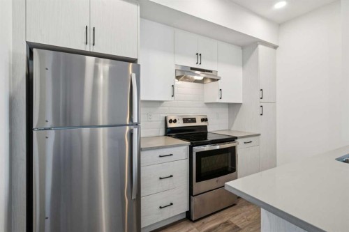903-24 Rivercrest Drive, Cochrane, AB - Indoor Photo Showing Kitchen With Stainless Steel Kitchen With Upgraded Kitchen