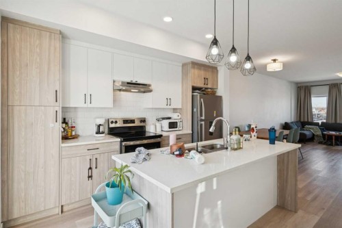 1502-24 Rivercrest Drive, Cochrane, AB - Indoor Photo Showing Kitchen With Stainless Steel Kitchen With Double Sink With Upgraded Kitchen