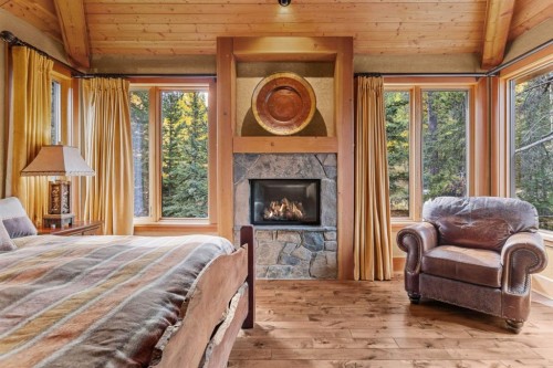 163 Cairns Landing, Canmore, AB - Indoor Photo Showing Bedroom With Fireplace