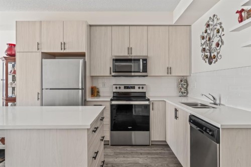 6302-151 Legacy Main Street Se, Calgary, AB - Indoor Photo Showing Kitchen With Stainless Steel Kitchen With Double Sink
