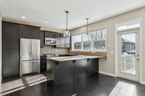 33 Sundown Grove, Cochrane, AB - Indoor Photo Showing Kitchen With Upgraded Kitchen