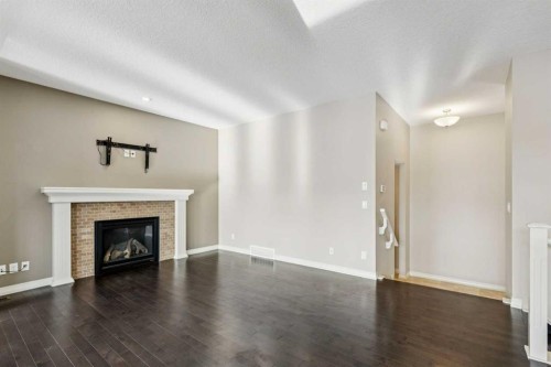 33 Sundown Grove, Cochrane, AB - Indoor Photo Showing Living Room With Fireplace