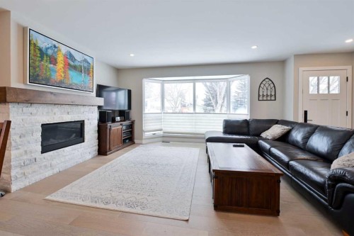 6427 Lombardy Crescent Sw, Calgary, AB - Indoor Photo Showing Living Room With Fireplace