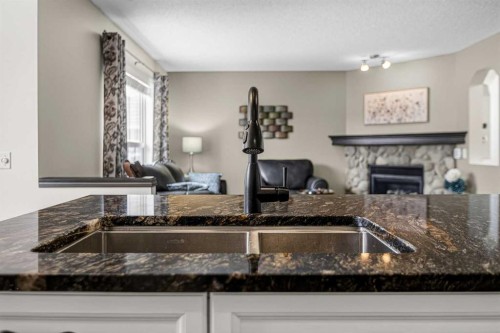 327 Chaparral Drive Se, Calgary, AB - Indoor Photo Showing Kitchen With Fireplace With Double Sink
