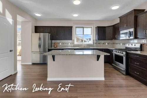 207 River Heights Crescent, Cochrane, AB - Indoor Photo Showing Kitchen With Upgraded Kitchen