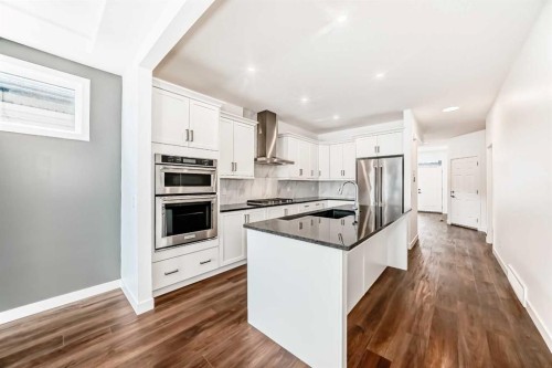 63 Riviera Court, Cochrane, AB - Indoor Photo Showing Kitchen With Upgraded Kitchen