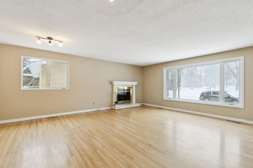389 Capri Avenue Nw, Calgary, AB - Indoor Photo Showing Living Room With Fireplace