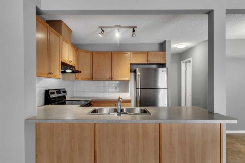 68 Panatella Villas Nw, Calgary, AB - Indoor Photo Showing Kitchen With Double Sink