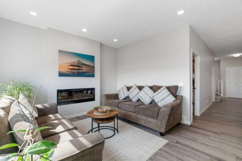 234 Carringsby Way Nw, Calgary, AB - Indoor Photo Showing Living Room With Fireplace