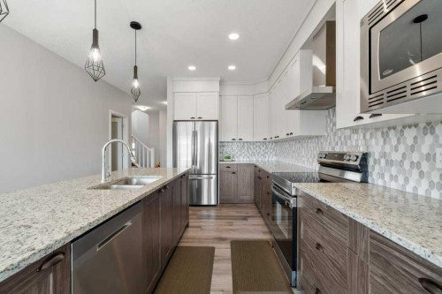 234 Carringsby Way Nw, Calgary, AB - Indoor Photo Showing Kitchen With Stainless Steel Kitchen With Double Sink With Upgraded Kitchen