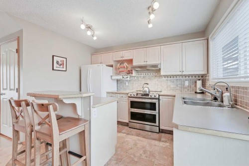 312 Cramond Close Se, Calgary, AB - Indoor Photo Showing Kitchen With Double Sink