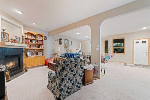 16 Arbour Estates View Nw, Calgary, AB - Indoor Photo Showing Living Room With Fireplace
