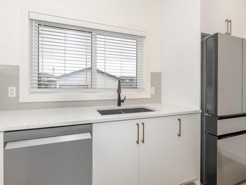 613 Lambeau Link Se, Airdrie, AB - Indoor Photo Showing Kitchen With Double Sink
