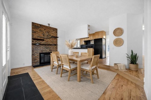 128 Bermuda Drive Nw, Calgary, AB - Indoor Photo Showing Dining Room With Fireplace