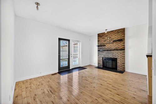 128 Bermuda Drive Nw, Calgary, AB - Indoor Photo Showing Other Room With Fireplace
