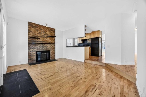 128 Bermuda Drive Nw, Calgary, AB - Indoor Photo Showing Living Room With Fireplace