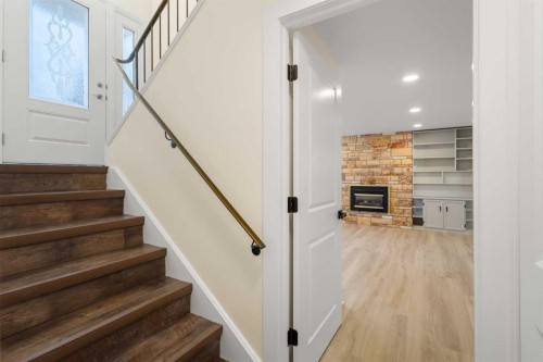 95 Silver Brook Drive Nw, Calgary, AB - Indoor Photo Showing Other Room With Fireplace