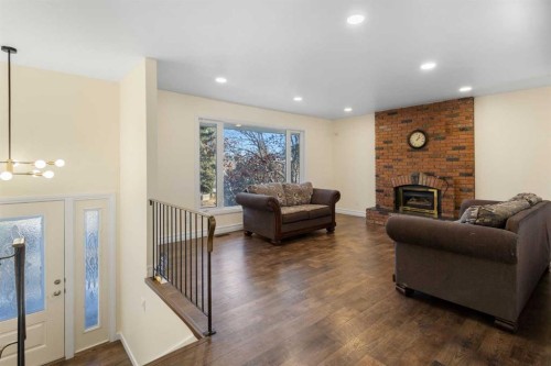 95 Silver Brook Drive Nw, Calgary, AB - Indoor Photo Showing Living Room With Fireplace