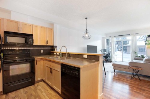 1116-211 Aspen Stone Boulevard Sw, Calgary, AB - Indoor Photo Showing Kitchen With Double Sink