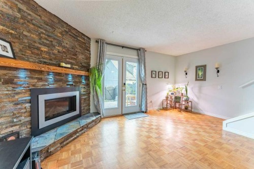 9-6503 Ranchview Drive Nw, Calgary, AB - Indoor Photo Showing Living Room With Fireplace
