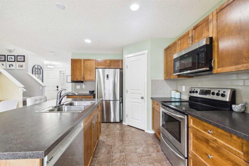 121 River Heights Crescent, Cochrane, AB - Indoor Photo Showing Kitchen With Double Sink