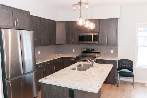 401-250 Fireside View, Cochrane, AB - Indoor Photo Showing Kitchen With Double Sink With Upgraded Kitchen