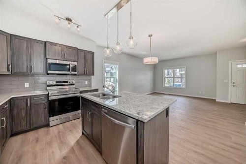 401-250 Fireside View, Cochrane, AB - Indoor Photo Showing Kitchen With Double Sink With Upgraded Kitchen