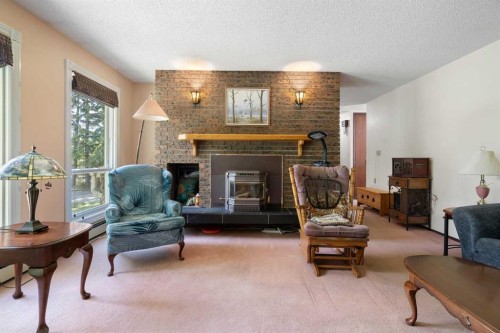 4214 50 Avenue, Olds, AB - Indoor Photo Showing Living Room With Fireplace