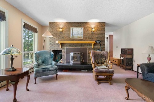 4214 50 Avenue, Olds, AB - Indoor Photo Showing Living Room With Fireplace