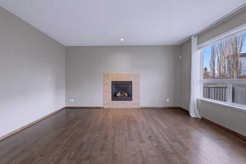 244 Eversyde Mews Sw, Calgary, AB - Indoor Photo Showing Living Room With Fireplace