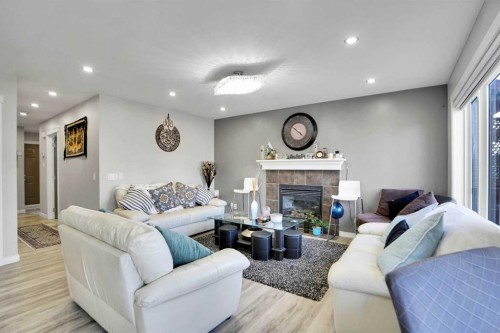 91 Copperstone Gate Se, Calgary, AB - Indoor Photo Showing Living Room With Fireplace