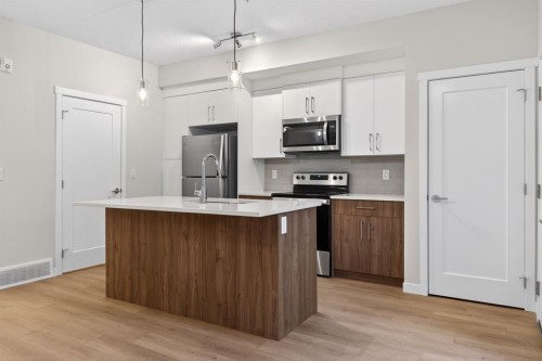 203-400 Belmont Street Sw, Calgary, AB - Indoor Photo Showing Kitchen With Stainless Steel Kitchen With Upgraded Kitchen