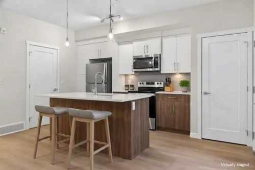 203-400 Belmont Street Sw, Calgary, AB - Indoor Photo Showing Kitchen With Stainless Steel Kitchen With Upgraded Kitchen