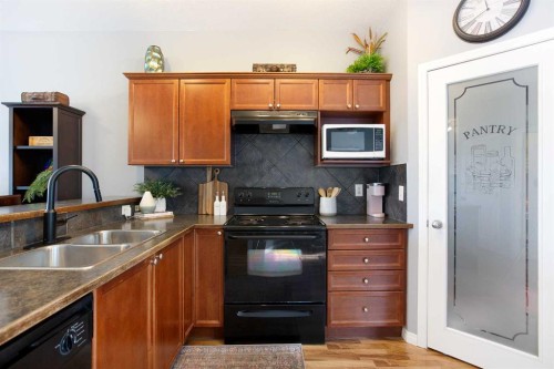 404-703 Luxstone Square Sw, Airdrie, AB - Indoor Photo Showing Kitchen With Double Sink