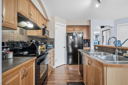 4 Tuscany Ridge Way Nw, Calgary, AB - Indoor Photo Showing Kitchen With Double Sink