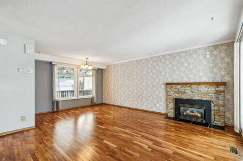 3412 Temple Road Ne, Calgary, AB - Indoor Photo Showing Living Room With Fireplace