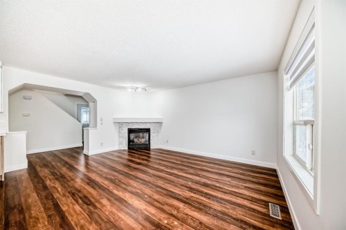 87 Bridlepost Green Sw, Calgary, AB - Indoor Photo Showing Living Room With Fireplace