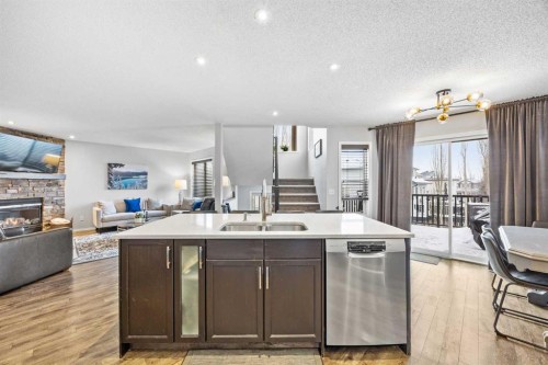 390 Cove Road, Chestermere, AB - Indoor Photo Showing Kitchen With Fireplace With Double Sink