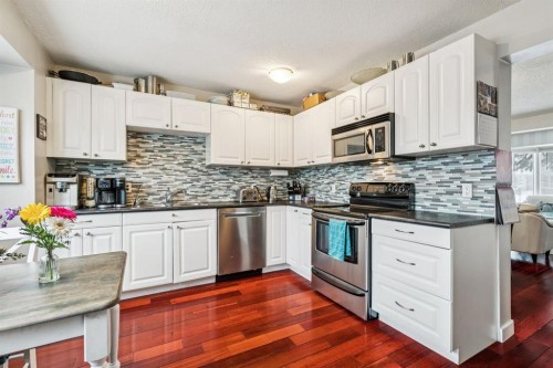 107 Sunbank Way Se, Calgary, AB - Indoor Photo Showing Kitchen With Double Sink With Upgraded Kitchen