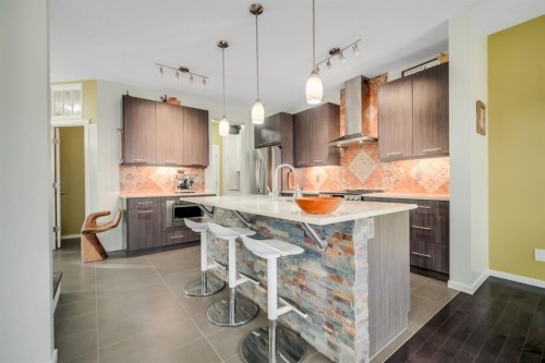 12 Sunrise View, Cochrane, AB - Indoor Photo Showing Kitchen With Upgraded Kitchen