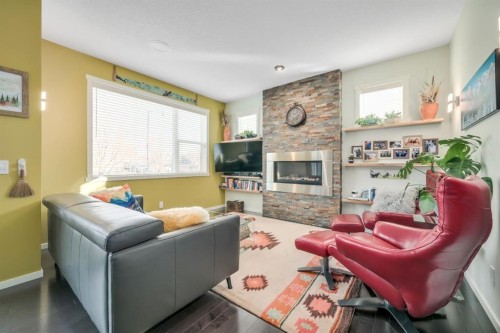 12 Sunrise View, Cochrane, AB - Indoor Photo Showing Living Room With Fireplace