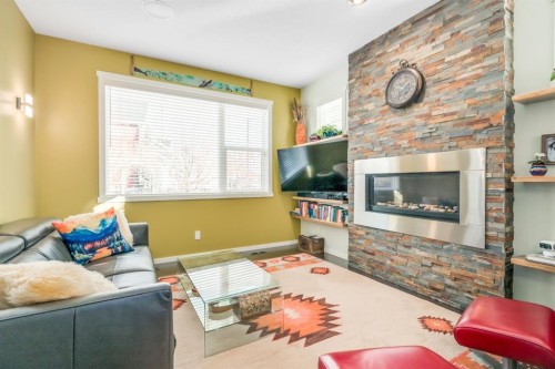 12 Sunrise View, Cochrane, AB - Indoor Photo Showing Living Room With Fireplace