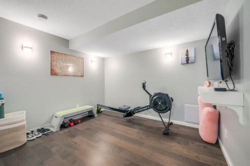 12 Sunrise View, Cochrane, AB - Indoor Photo Showing Gym Room