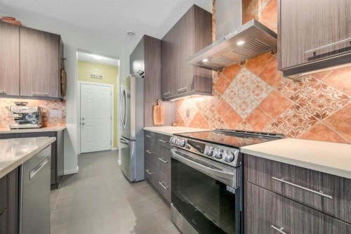 12 Sunrise View, Cochrane, AB - Indoor Photo Showing Kitchen With Upgraded Kitchen