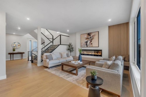 28 Spring Creek Point Sw, Calgary, AB - Indoor Photo Showing Living Room With Fireplace