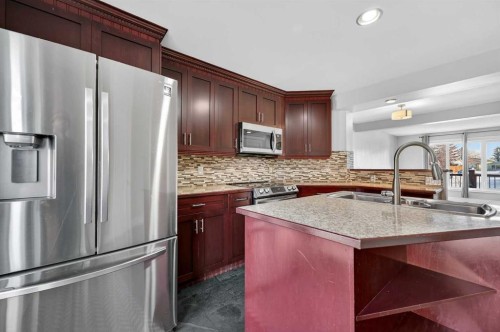 132 Erin Grove Close Se, Calgary, AB - Indoor Photo Showing Kitchen With Stainless Steel Kitchen With Double Sink With Upgraded Kitchen