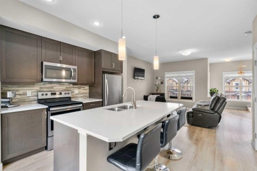603-32 Horseshoe Crescent, Cochrane, AB - Indoor Photo Showing Kitchen With Stainless Steel Kitchen With Double Sink With Upgraded Kitchen