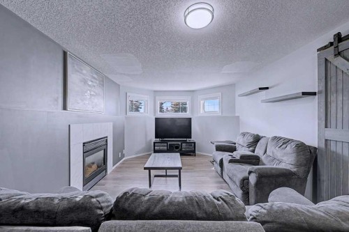 24 Sunlake Circle Se, Calgary, AB - Indoor Photo Showing Living Room With Fireplace