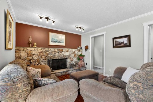 168 Midlake Boulevard Se, Calgary, AB - Indoor Photo Showing Living Room With Fireplace