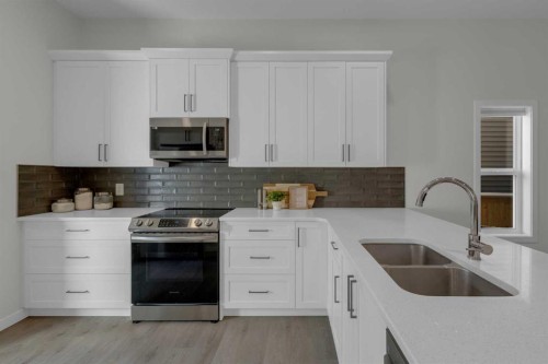 812 Reynolds Manor Sw, Airdrie, AB - Indoor Photo Showing Kitchen With Double Sink